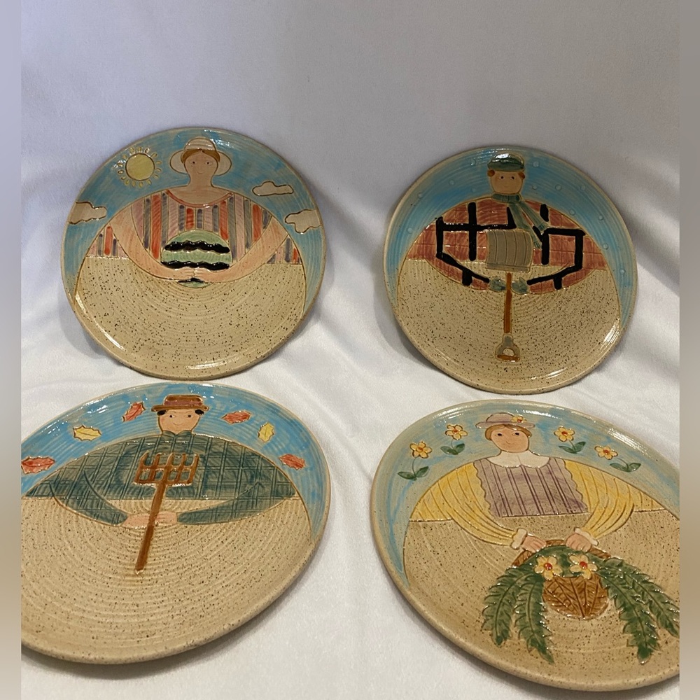 Set of four folk craft hand painted pottery plates. Seasons collection